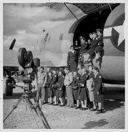 A.R.C. nurses pose in and outside the cargo door of C-46 transport plane.
