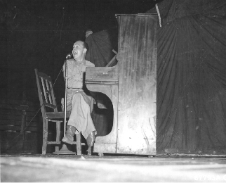 Harry Barris playing piano during show at Dinjan, India.